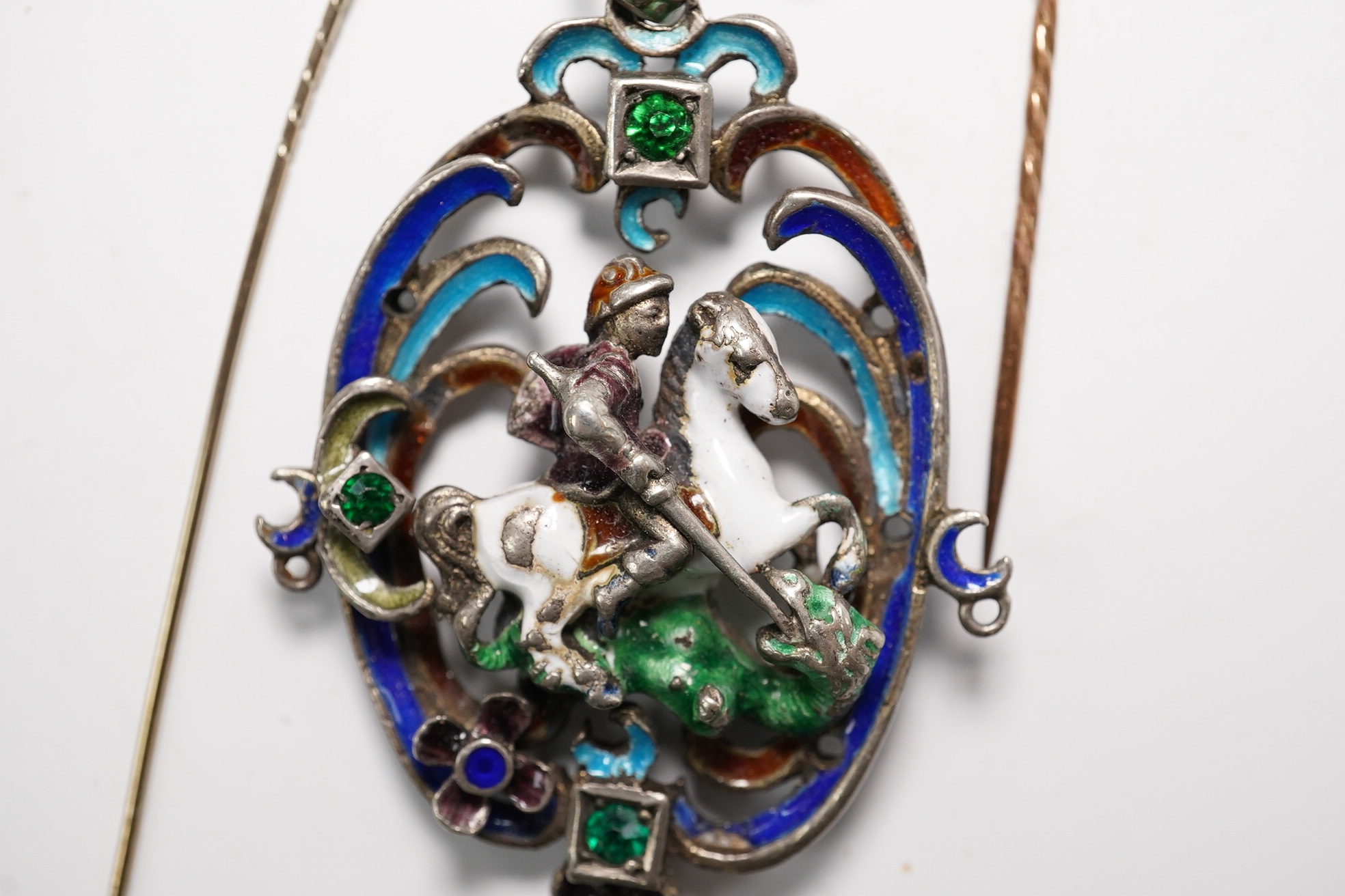 An Austro-Hungarian? white metal and polychrome enamel set St. George & the Dragon, drop pendant, 55mm and two stick pins. Condition - poor to fair